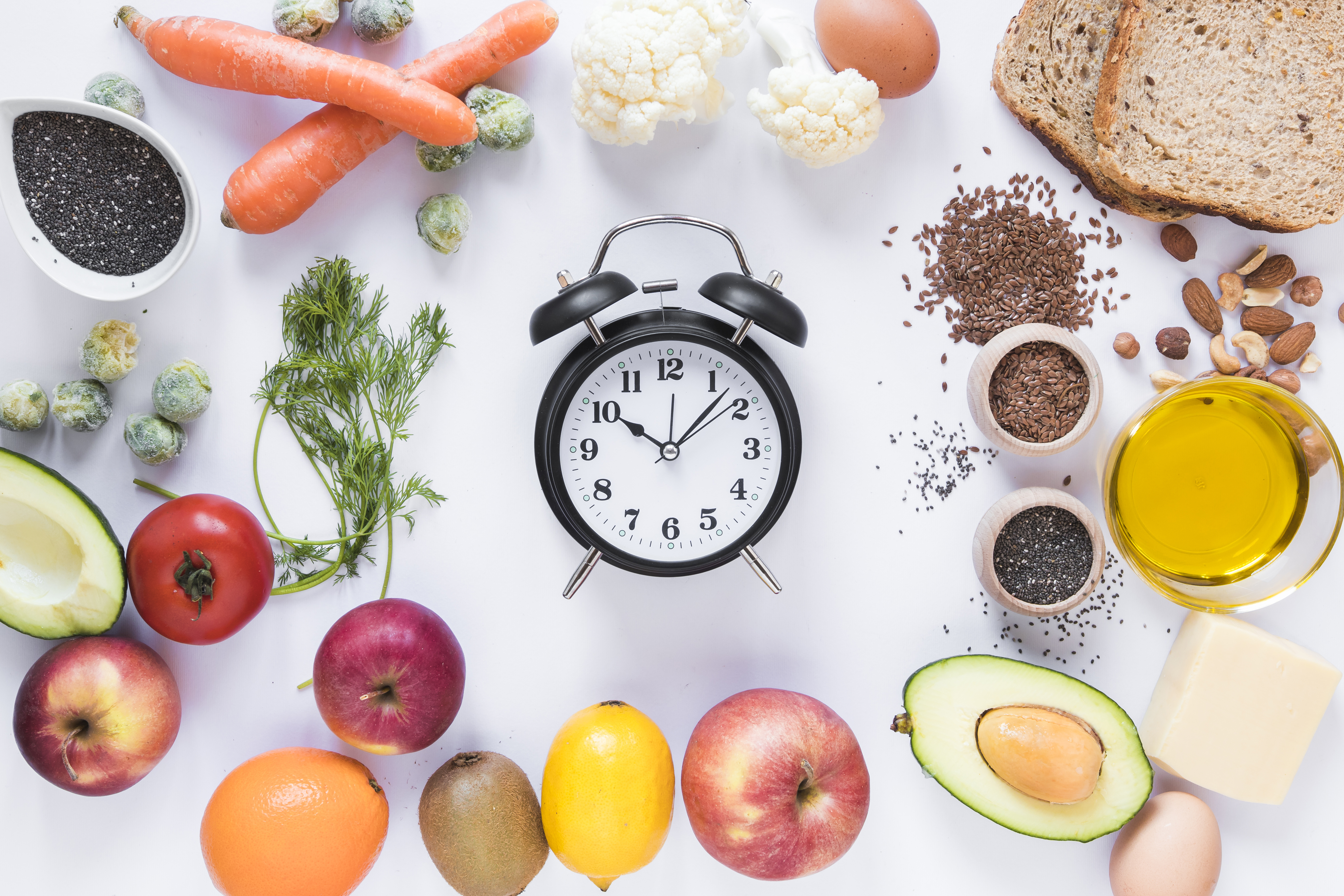 Picture of healthy foods, vegetables, and fruits around a clock